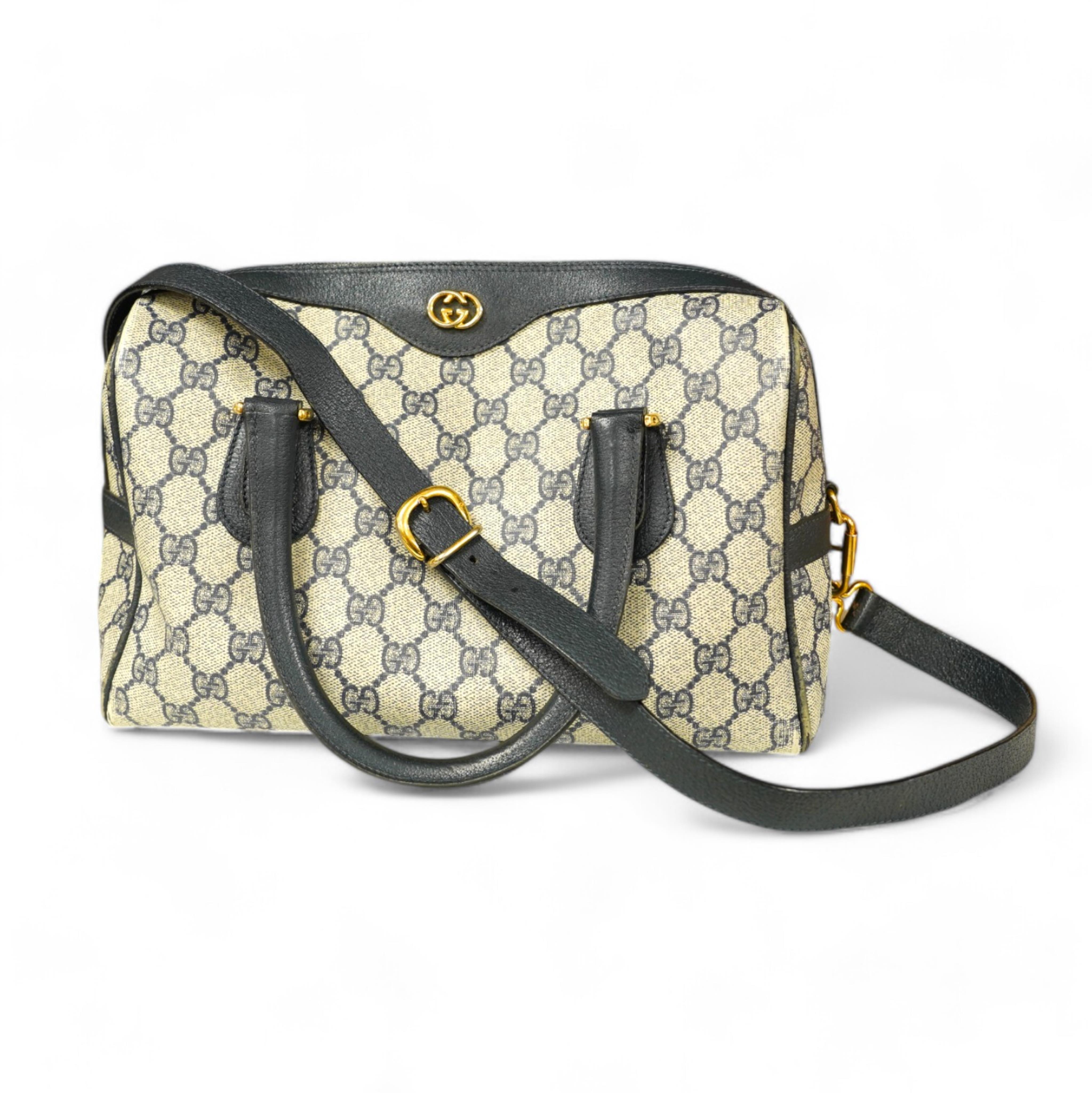 A Gucci monogram blue canvas handbag, wallet and purse